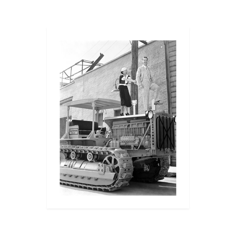 Sourire de Joe E. Brown et June Travis debout sur un tracteur - photographie non encadrée, H 10 po x l 8 po