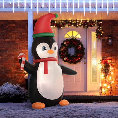 Pingouin tenant une canne de Noël gonflable