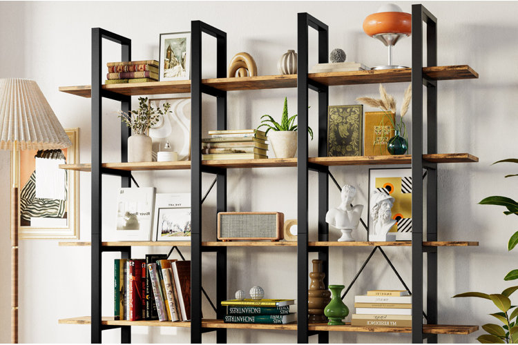 modern etagere with black metal framing and wooden shelves styled with books, vases, plants, and decorative accents