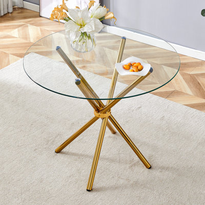 Table de salle à manger ronde en verre transparent avec une forme unique pour 4 à 6 personnes, avec des pieds en métal doré rassemblés en forme d'anneau, convenant aux bureaux, aux cuisines, aux terrasses et aux salles à manger.