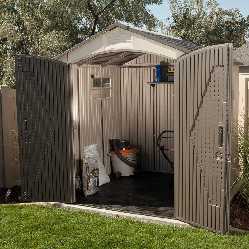 Tan and Brown Polyethylene Outdoor Storage Shed with Shelving and Windows
