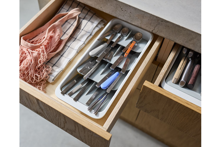 kitchen drawer with organized flatware, knives, and kitchen linens