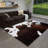 Dark brown cowhide-textured modern non-slip indoor area rug, machine washable and foldable, suitable for living rooms, hotels, apartments, and dormitories.