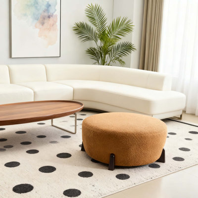 Modish Round Ottoman: Boucle Top With Splayed Rubber Wood Legs, Pumpkin Orange