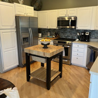 Behling Solid Butcher Block Kitchen Island with Baskets and Storage Shelf