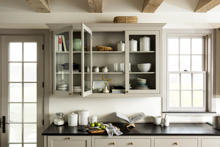 organized kitchen cabinets with dinnerware and drinkware on the shelves