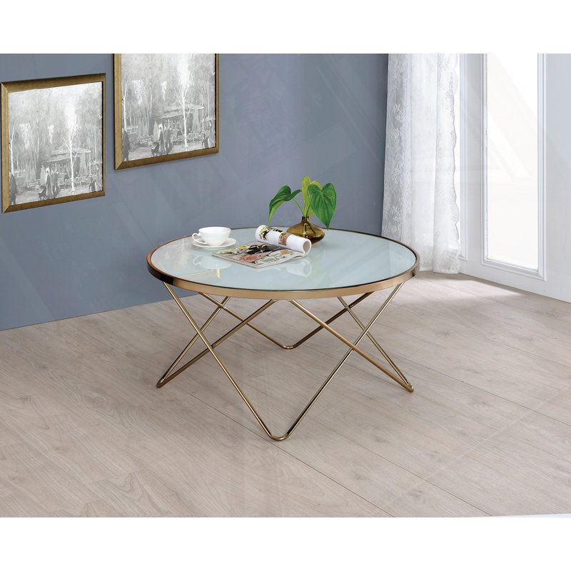 Table basse avec plateau en verre givré et finition champagne