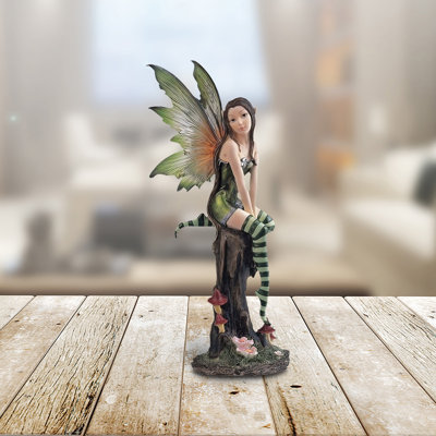 8"H Green Fairy with Clear Wings Sitting on Tree Trunk Figurine