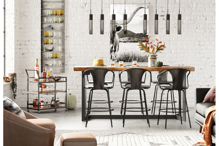 industrial farmhouse dining/kitchen with white brick walls, wood and steel seats and dining table, and black and white artwork