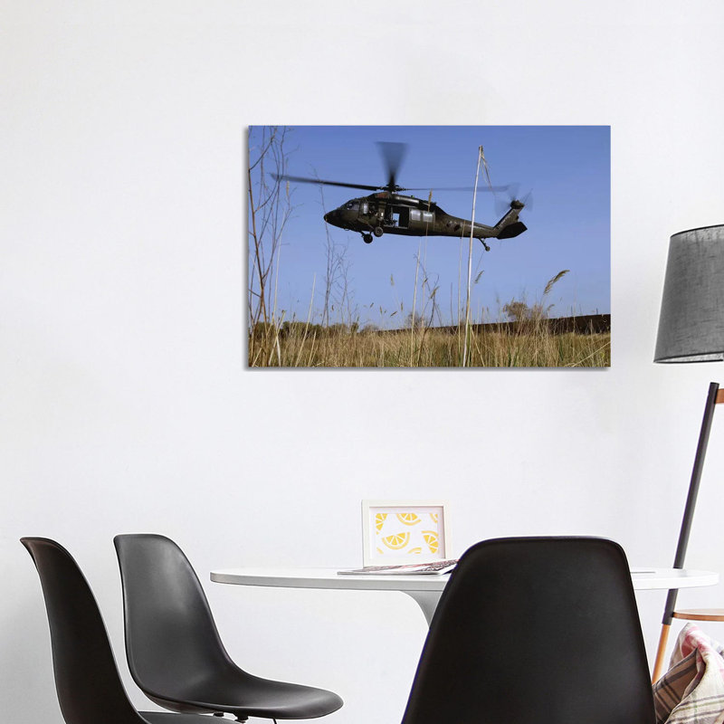 A US Army UH-60 Black Hawk Helicopter Prepares To Pick Up Soldiers by Stocktrek Images - Wrapped Canvas Gallery-Wrapped Canvas Giclée