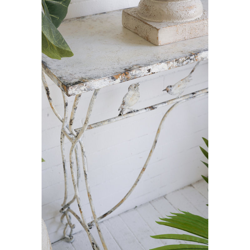 Console de 109 x 42 x 86 cm avec perchoir pour oiseau en fer vieilli, pieds torsadés, aspect blanc patiné. Un élément décoratif fantaisiste pour une entrée ou un couloir.