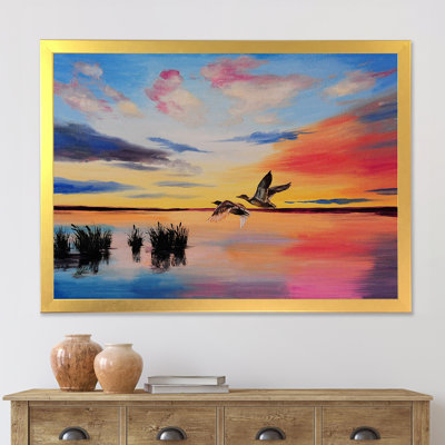 Grues volant pendant un coucher de soleil coloré - peinture sur toile