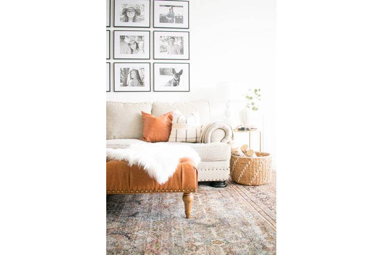 living room with beige sofa and leather ottoman
