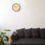 Horloge murale ronde à cadran en bois naturel et cadre noir