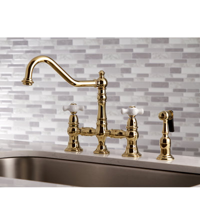 Kingston Brass Restoration Two-Handle 4-Hole Deck Mount Bridge Kitchen Faucet with Brass Side Sprayer