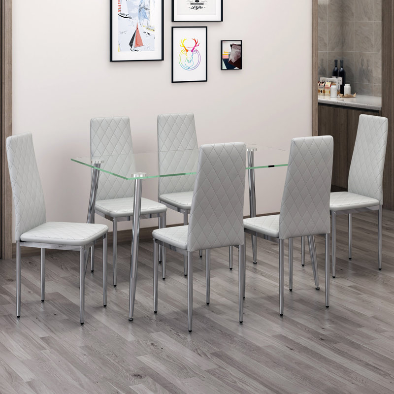 Ensemble de salle à manger moderne et minimaliste avec plateau en verre et pieds en métal argenté pour la cuisine et le salon