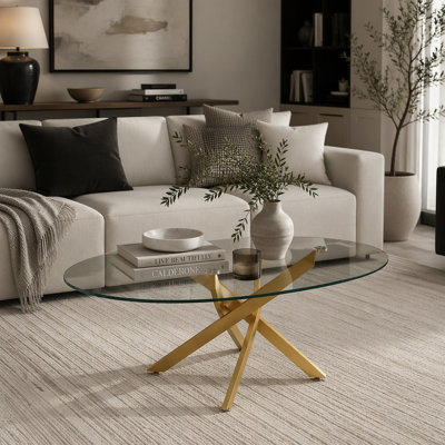 Table basse ovale en verre avec pattes croisées dorées et plateau en verre trempé