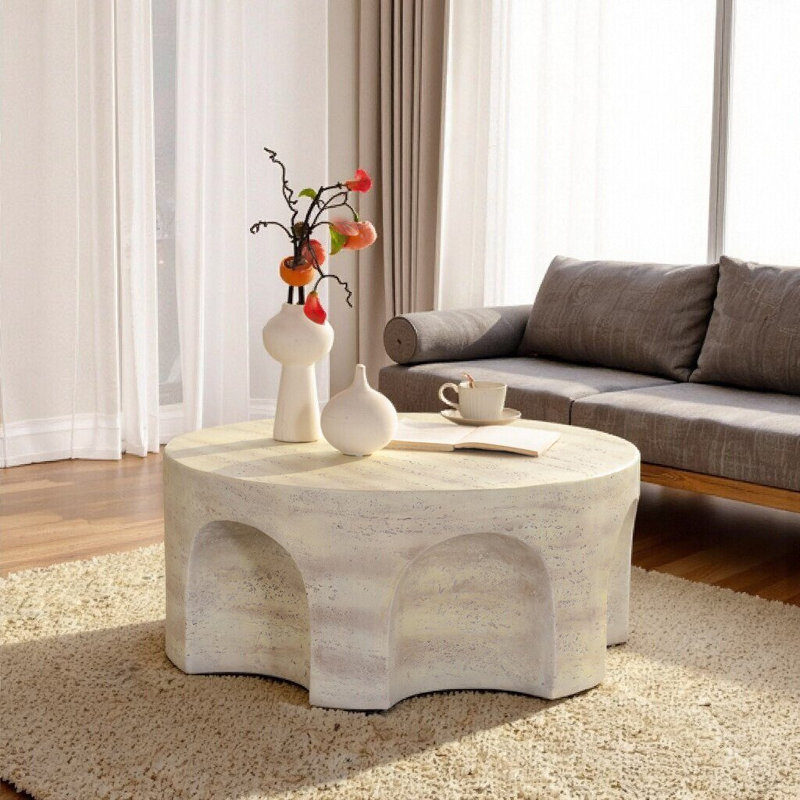Table basse ronde avec base arquée