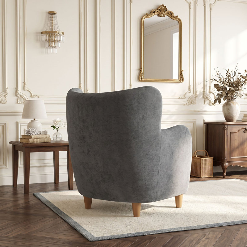 Fauteuil à oreilles avec pieds en bois massif et coussin à ressorts ensachés pour salon ou chambre