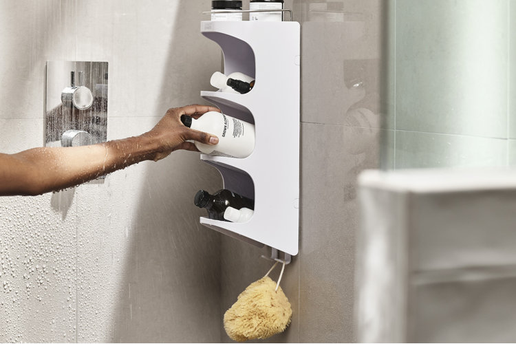 white shower caddy with a woman reaching in to get a product