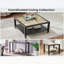 Table basse industrielle carrée avec structure en acier noir mat et plateau en verre doré pour les espaces de vie modernes