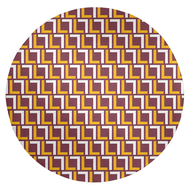 Tapis rond rouge / jaune à motif géométrique