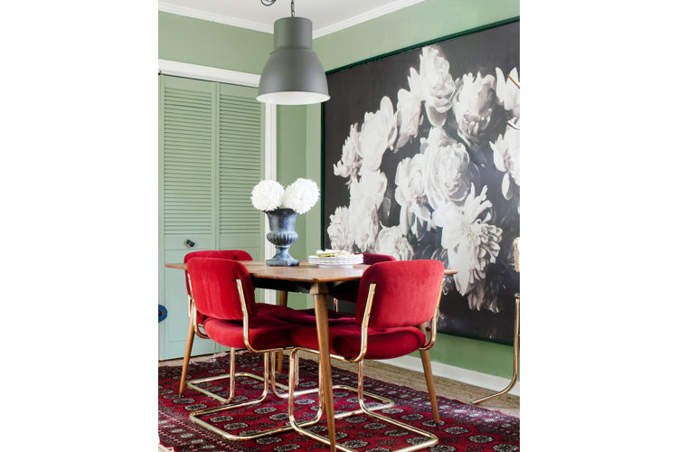 Red velvet chairs at a dining room table 