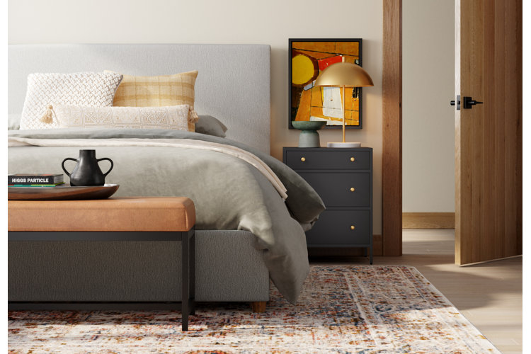 Modern bedroom with gray bed and bed set brown upholstered and metal framed bench and dark blue nightstand with gold dome shape table lamp