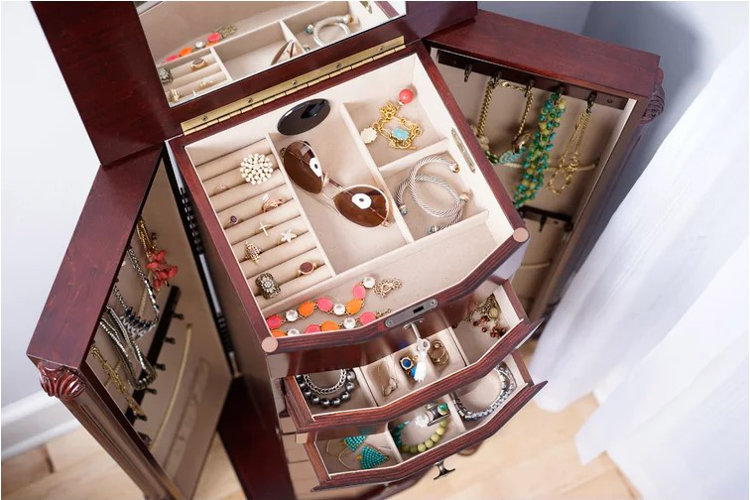 brown jewelry box with an assortment of jewelry and accessories 
