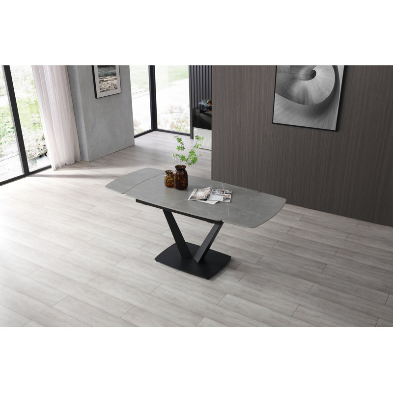 Table de salle à manger extensible de style marbre avec base en V sculpturale noire