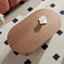 Table basse en panneau de fibres à densité moyenne brun pour une vie compacte, conception ovale moderne avec base piédestal