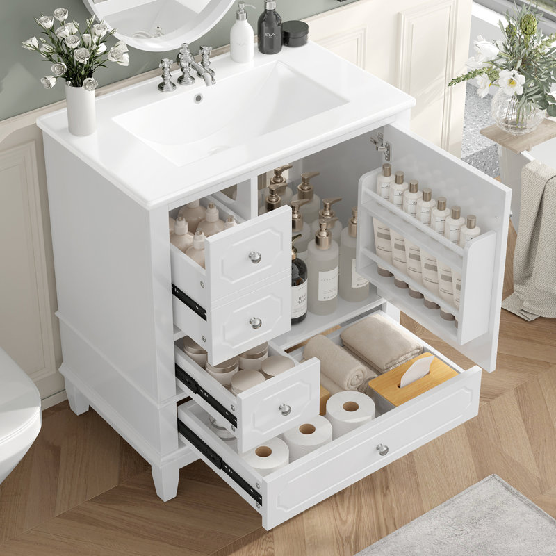 Meuble-lavabo autoportant avec lavabo en céramique, structure en bois massif, porte à fermeture en douceur, tiroirs et tablettes de rangement pour une vie pratique et élégante.