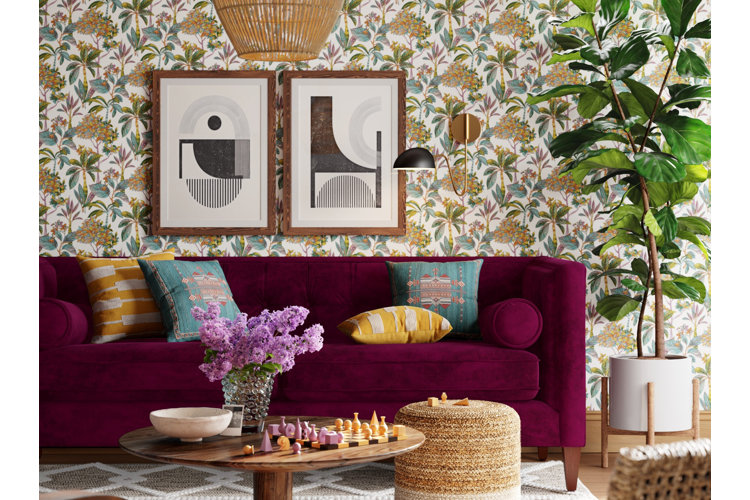 living room with floral wallpaper, purple sofa with blue and yellow throw pillows, and framed wall art