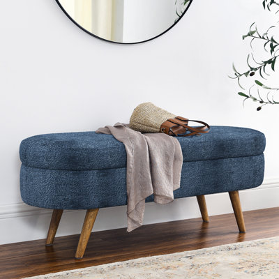 Meuble de rangement ovale bleu foncé avec pieds robustes en bois d'hévéa, pouvant supporter jusqu'à 113 kg, fabriqué à la main, pouvant servir de repose-pieds ou de siège.