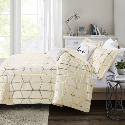 Couette Twin/Twin XL avec motif géométrique doré métallisé.