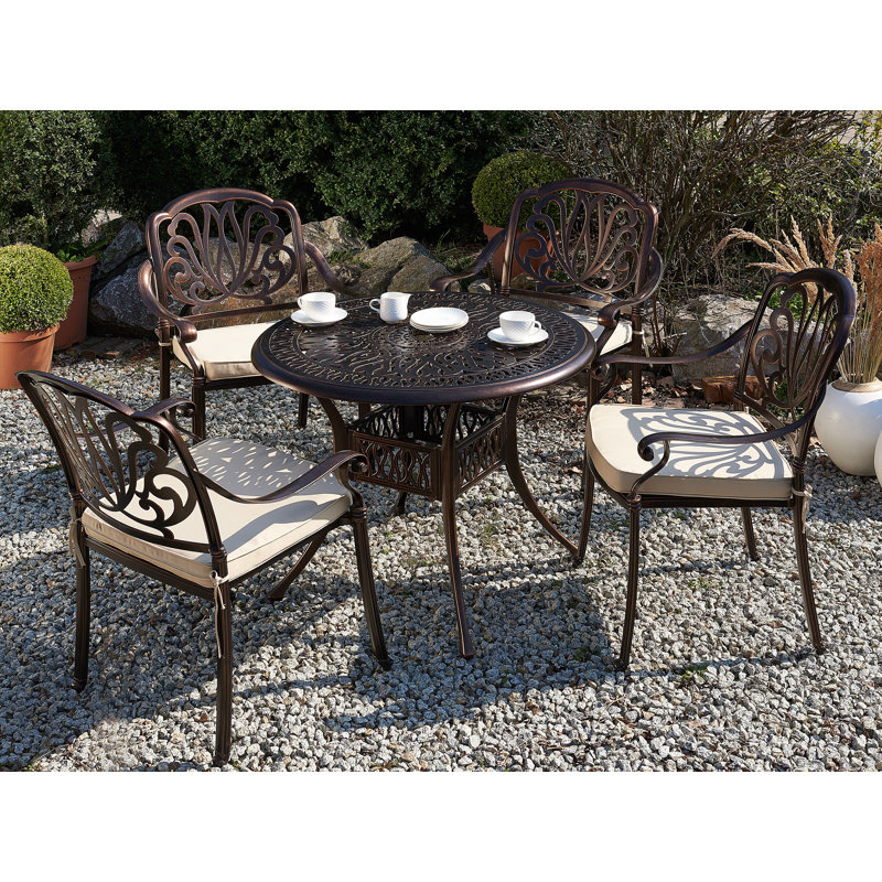 Aadhiran 4 - Person Patio Dining Set with Round Table , Cushions Included