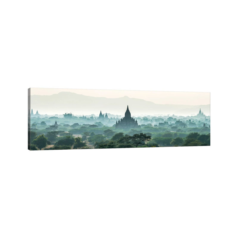 Early Morning Fog Over The Temples In Bagan, Myanmar by Jan Becke - Wrapped Canvas Panoramic Print