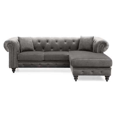 Canapé rembourré moderne et chic avec généreux sièges, conception capitonnée et coussins décoratifs assortis pour une expérience de salon luxueuse.