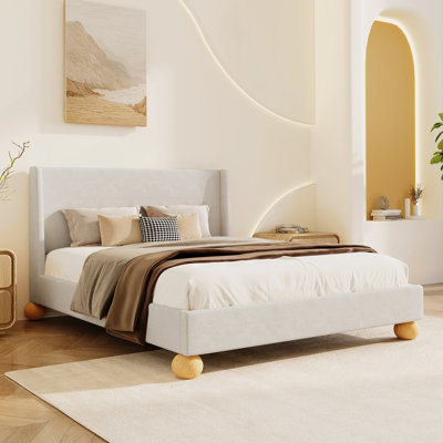 Lit plateforme tapissier moderne avec tête de lit à oreilles et pieds ronds en bois
