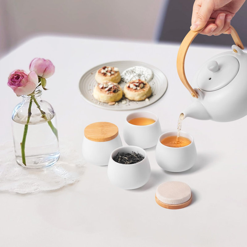 Théière en céramique 20 oz avec 4 tasses à thé, théière en porcelaine de style japonais, théière à feuilles mobiles et tasses à thé en fleurs avec poignée en bois courbé pour les femmes (blanc brillant)