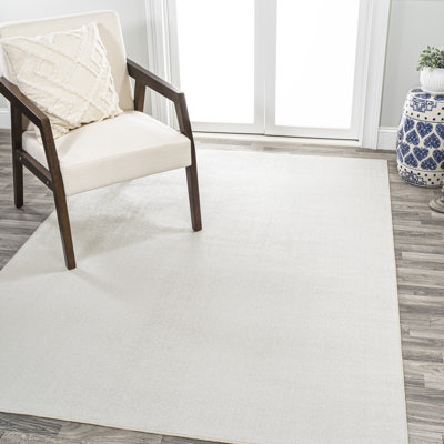 Yaniyah Classic Solid Low-Pile Machine-Washable Cream Rug
