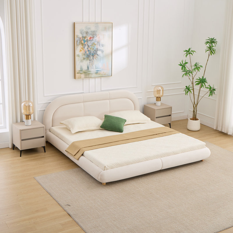 Lit plateforme moderne tapissier à profil bas avec tête de lit arrondie, pour les chambres contemporaines et le confort élégant.