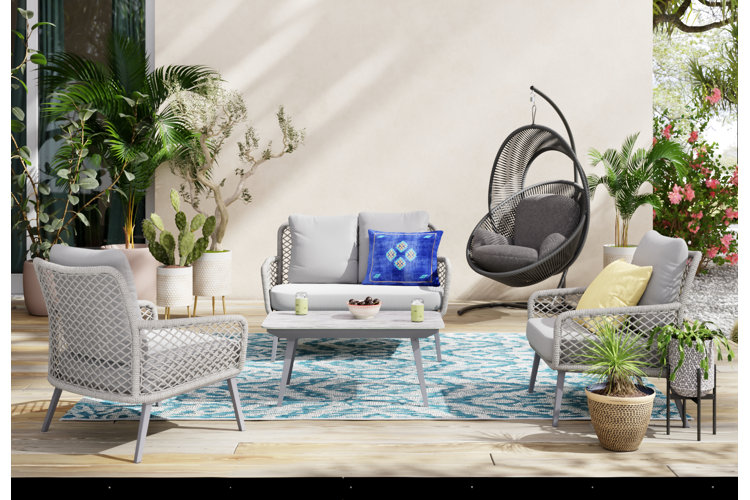 back porch with a gray conversation set and a hanging chair