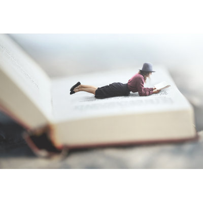 Woman Lying On Book - Wrapped Canvas Print