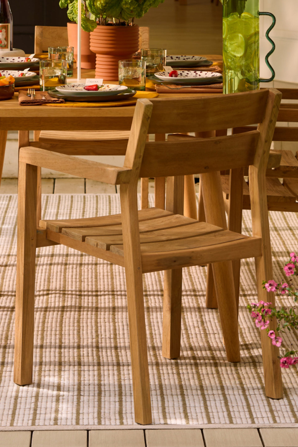 Wooden chair at an outdoor dining table.