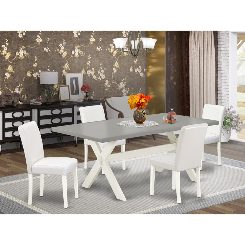L'ensemble de mobilier de salle à manger 5 pièces comprend une table rectangulaire avec pieds en X et 4 chaises rembourrées en similicuir blanc, lin brossé blanc 