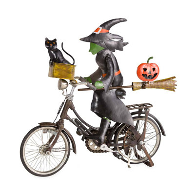Figurine sorcière sur un vélo