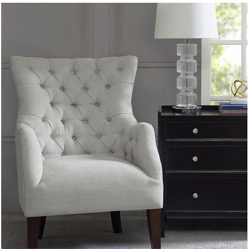 Fauteuil à oreilles capitonné