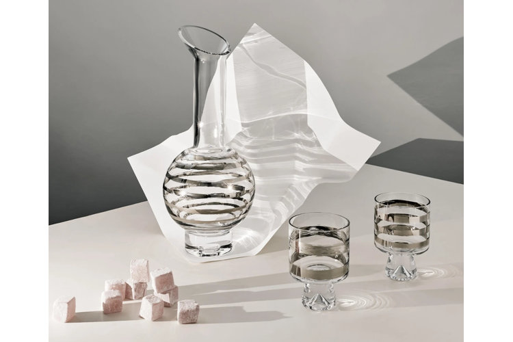 glass carafe with matching drinking glasses sitting on a table
