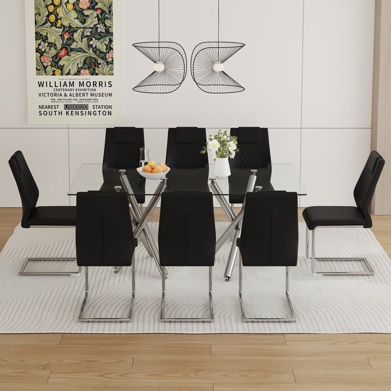 Ensemble de table de salle à manger moderne et luxueux en verre transparent avec 8 chaises - pieds en métal argenté et sièges en cuir PU noir